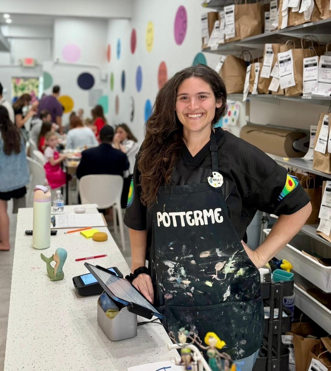 Jenna Helfman, PotterMe founder and artist, smiling inside the Surfside studio
