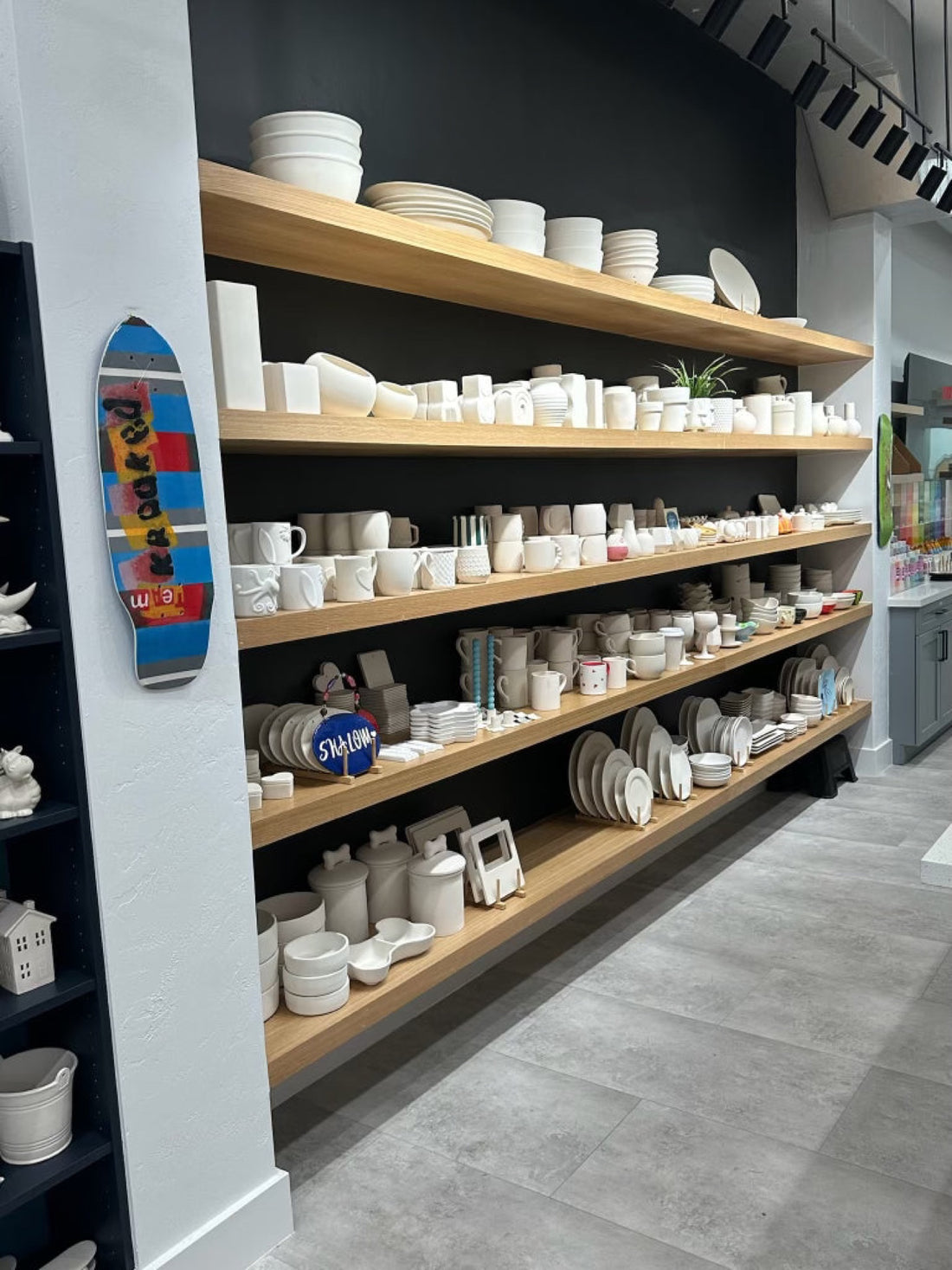 Wall of blank pottery ready to paint inside PotterMe in Surfside